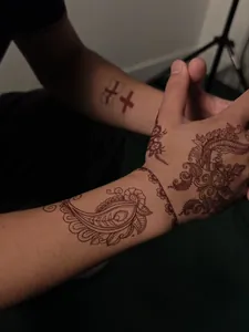 Detailed macro shot of intricate Henna tattoo stickers on hand and wrist