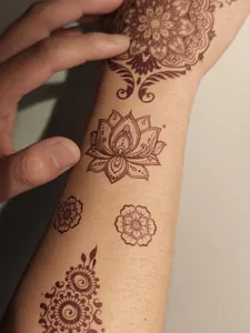 Detailed shot of Indian henna matte tattoo stickers with lotus design on skin