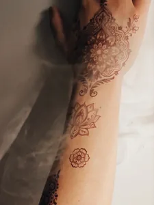 Indian henna matte tattoo sticker with intricate mandala and lotus designs on arm