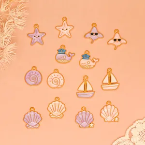 Detailed view of pastel purple and peach ocean-themed enamel charms for DIY jewelry making