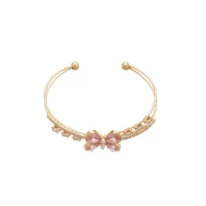Elegant gold double-layer cuff bracelet with pink zircon butterfly motif for women.