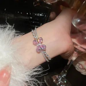 Close-up of pink zircon butterfly on a double-layer sparkling silver bracelet