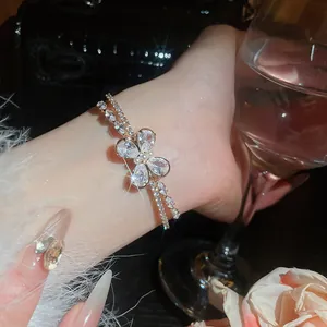 Close-up detail of sparkling zircon butterfly double-layered open bracelet on a wrist
