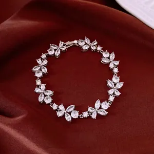 Elegant silver-tone zircon flower bracelet with marquise-cut stones on red fabric