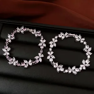 Elegant silver-tone flower bracelets with pink and clear cubic zirconia stones.