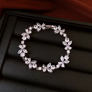 French luxury style zircon flower bracelet displayed on elegant black jewelry tray.