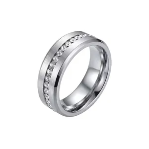 Detailed view of single row crystal encrusted stainless steel ring with brushed finish
