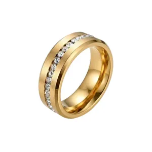 Close-up of a gold-plated stainless steel ring with a single row of inlaid crystals.