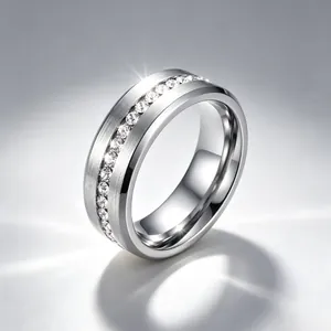 Detailed close-up of a brushed stainless steel ring with a single row of diamonds