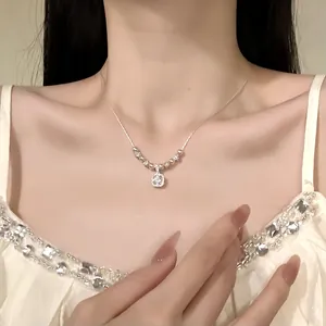Elegant silver-tone necklace featuring a square zircon pendant worn by a female model
