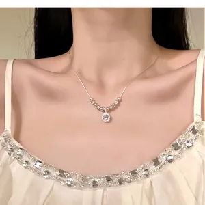 Close-up detail of an elegant zircon necklace pendant on a dainty silver chain