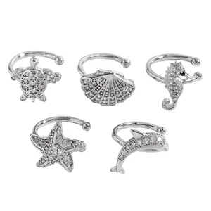 Detailed view of marine life ear cuffs set featuring sea turtle and dolphin designs.