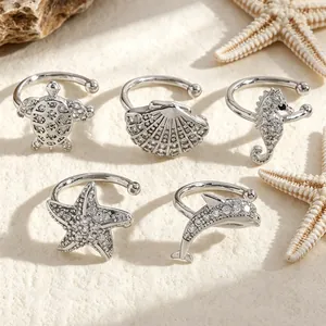 Detailed macro view of silver ocean-themed ear clips featuring zircon sea animals