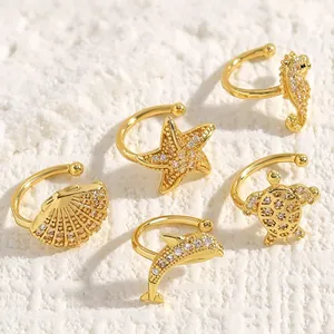 Detailed view of marine-themed zircon ear cuffs with shell and sea animal designs