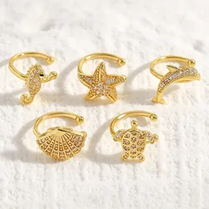 Detail view of five gold-plated ocean-themed ear cuffs featuring sparkling zircon stones.