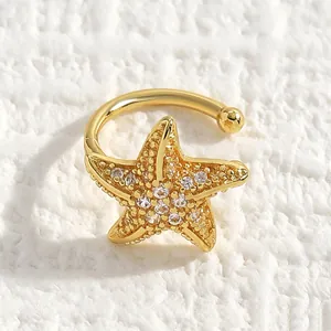 Detailed close-up view of a golden ocean-themed starfish ear cuff with sparkly zircons