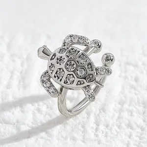 Close-up of a silver sea turtle ear cuff encrusted with sparkling cubic zirconia stones