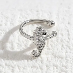 Macro view of a delicate silver seahorse ear cuff encrusted with sparkling zircon stones