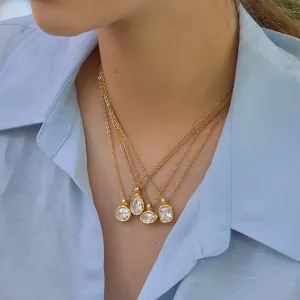 Close-up of layered gold necklaces with clear zircon pendants in various shapes.