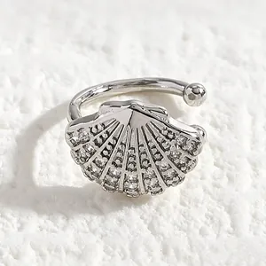 Macro detail of silver ocean-style shell ear cuff adorned with sparkling zircons