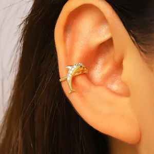 Close-up of gold-plated zircon dolphin ear cuff for non-pierced ears ocean style.