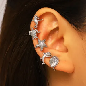 Detailed view of zircon-paved sea creature ear cuffs featuring seahorse and starfish