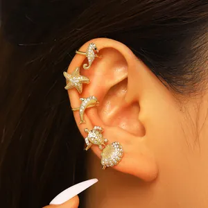 Marine themed gold ear cuffs set with zircon starfish seahorse shell and turtle