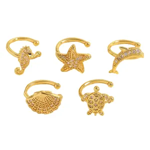 Detailed macro shot of five gold ocean-themed ear cuffs adorned with sparkling zirconia stones