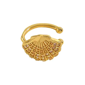 Detailed macro view of the ocean style gold shell ear cuff set with sparkling zircons.