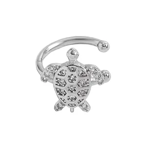 Detailed macro view of a silver-toned turtle ear cuff with sparkling zircon inlay.