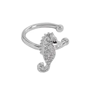 Detailed shot of silver seahorse ear cuff encrusted with sparkling cubic zirconia stones.