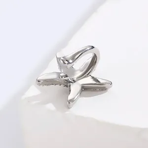 Detailed close-up of a minimalist silver starfish ear cuff with zircon ocean theme