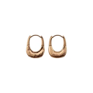Minimalist rose gold U-shaped hoop earrings featuring a unique textured and polished finish