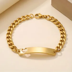 Detail view of a gold Cuban chain bracelet featuring a heart cutout curved plate
