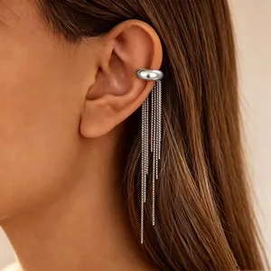 Detailed macro view of a silver stainless steel tassel ear cuff with long hanging chains.