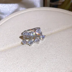 Close-up of sparkling zircon tassel ear cuff with elegant dangling stones