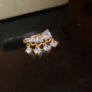 Macro shot of a sparkling zircon tassel ear cuff with elegant 18k gold plating.