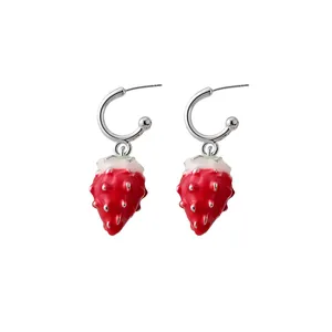 Vibrant red enamel strawberry drop earrings with silver hoops for a sweet summer look