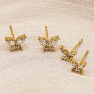 Close-up of elegant gold stainless steel butterfly stud earrings with clear zircon stones