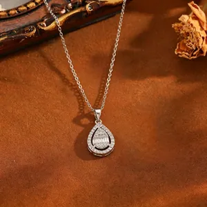 Detail of teardrop pendant necklace featuring sparkling crystals on a vintage background