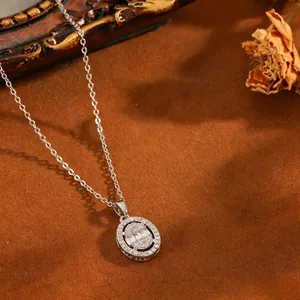 Close-up detail of an oval silver necklace pendant with sparkling baguette diamonds