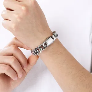 Close-up of minimalist silver titanium steel Cuban link bracelet with flip clasp