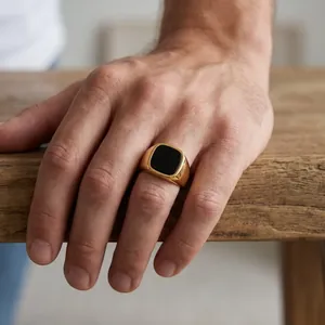 Men's vintage gold stainless steel signet ring with a polished black square onyx inlay.