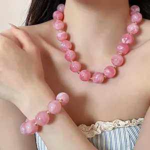 Pink acrylic round beaded necklace and bracelet set in vibrant dopamine style for women.