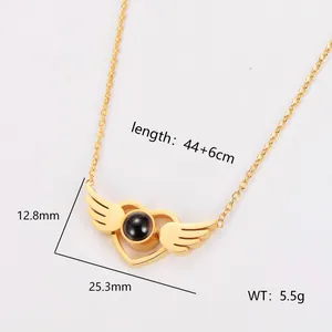 Macro detail of gold angel wing heart projection necklace with dimensions and weight