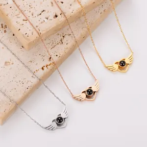 Close-up of angel wing projection necklaces in gold, rose gold, and silver finish