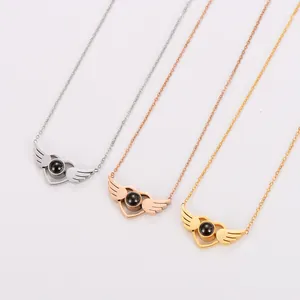 Three angel wing projection necklaces in silver, rose gold, and yellow gold finish.