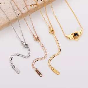 Detailed view of angel wing projection stone necklaces in three elegant finishes