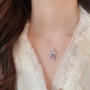 Elegant purple oil-drop bow necklace with floral zircon accents shown on a model neck