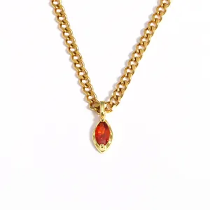 Detailed close-up of a gold stainless steel necklace with red marquise zircon pendant.